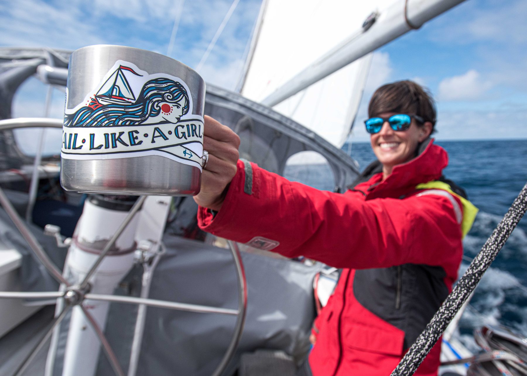 Becca sailing in her red foul-weather jacket